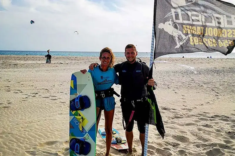 Victoria con un alumno al terminar su curso de kitesurf en la playa de Tarifa